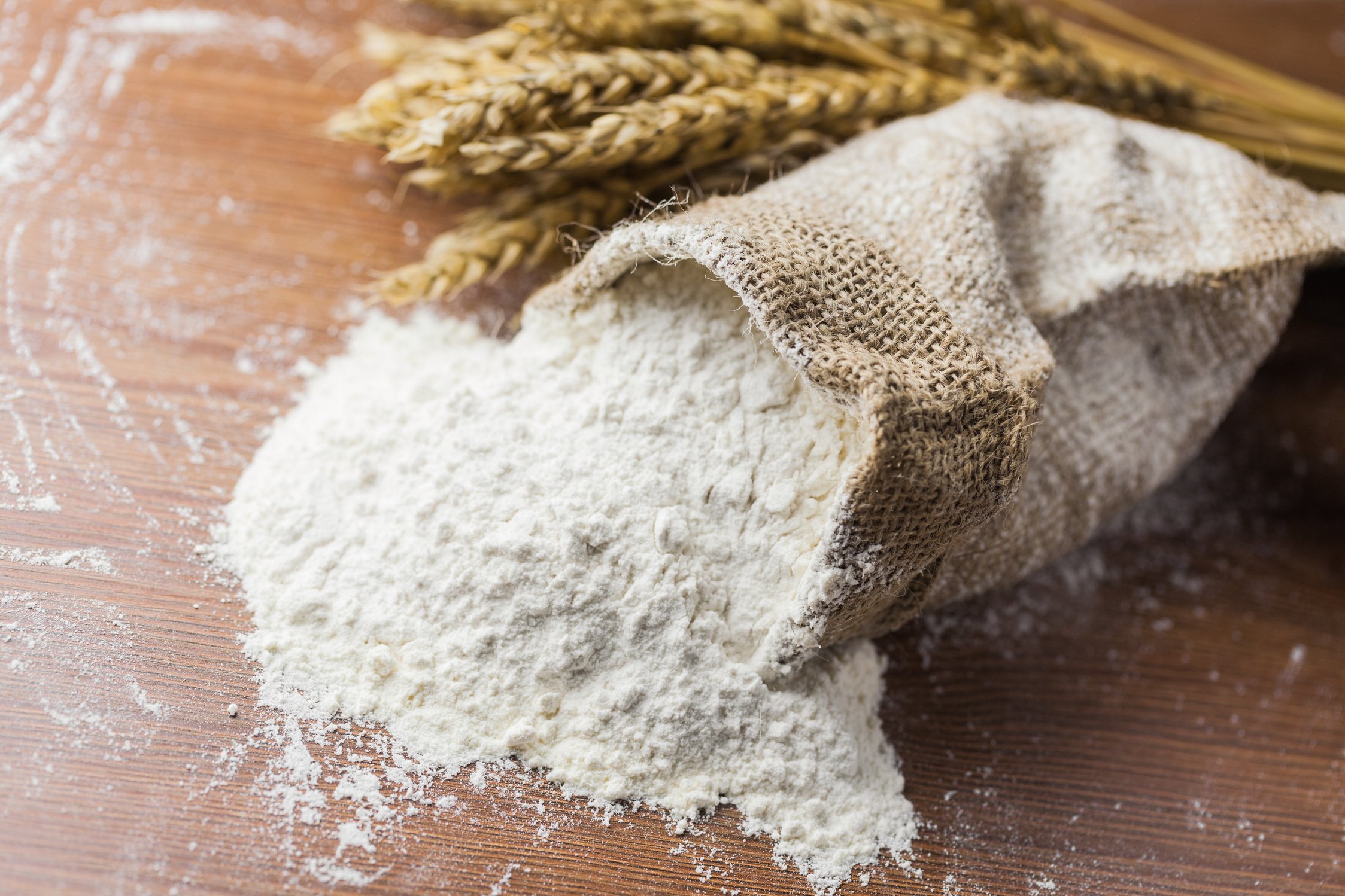 Flour on Wooden Surface Overflowing from a Sack